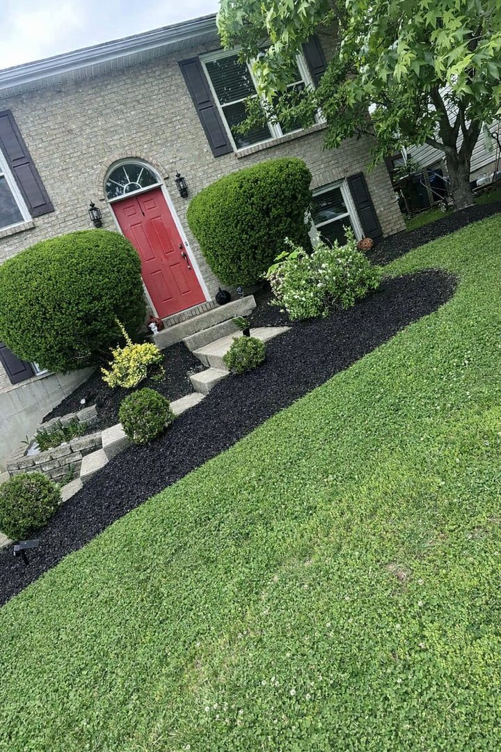 Front beds with fresh black mulch along the house and walk